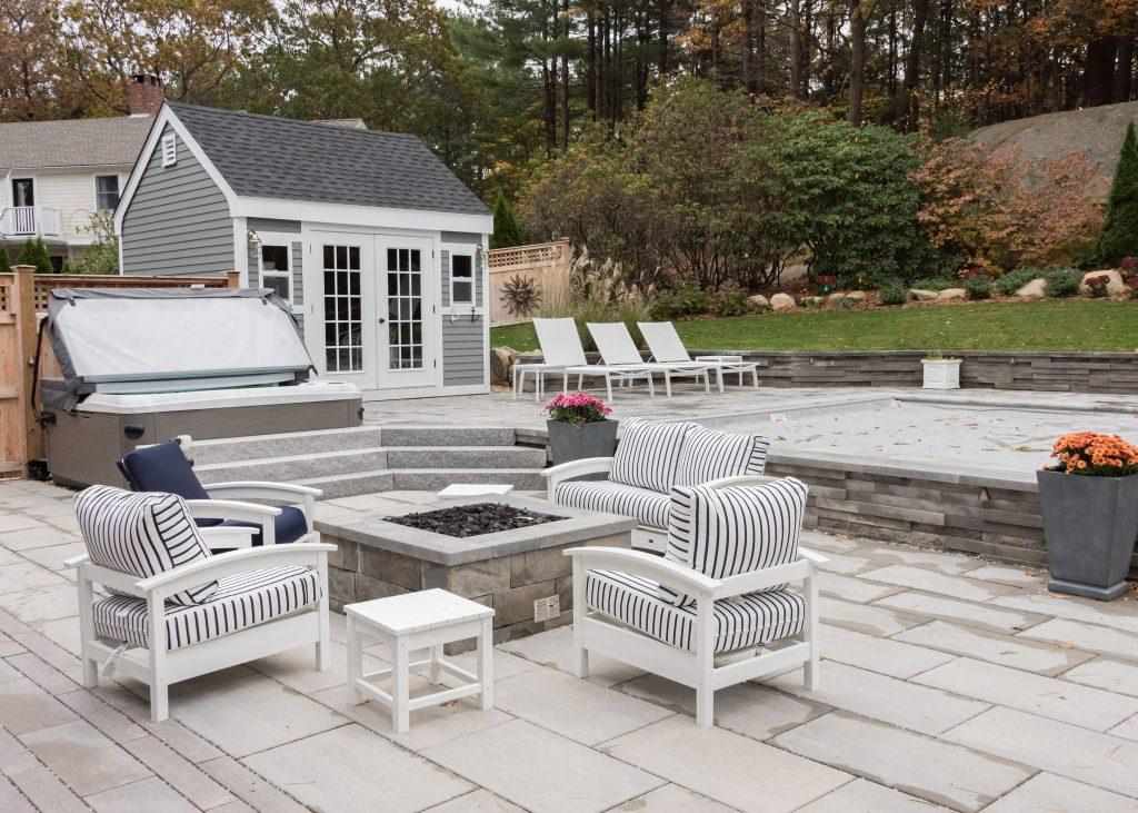 hardscape landscaping with stone patio and a square fire pit