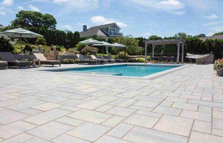 inground pool with stone patio pavers