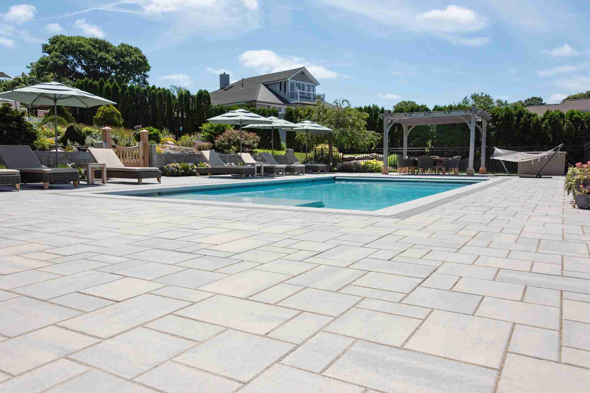 inground pool with stone patio pavers