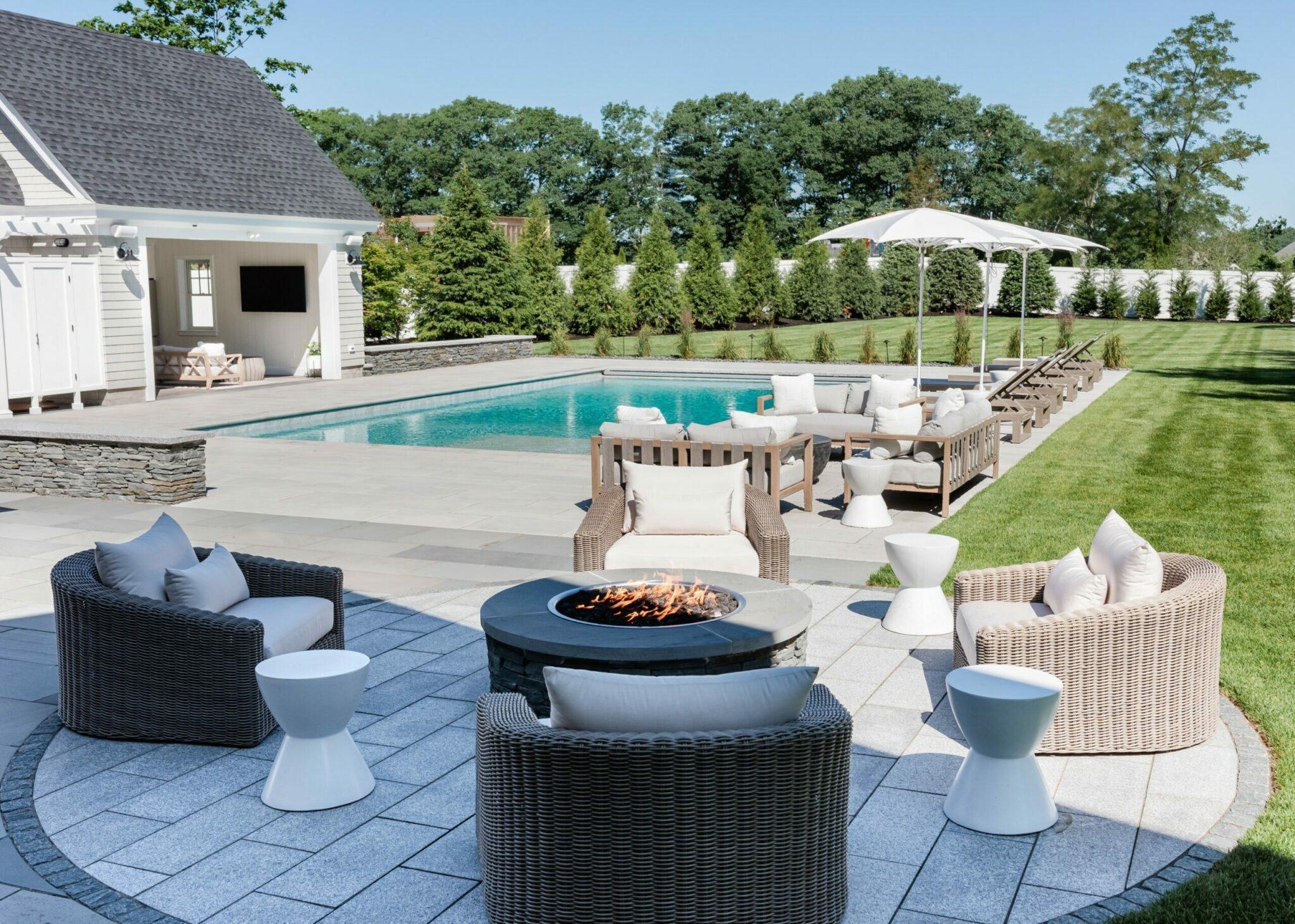 patio with fire pit, pool house and pool landscape projects
